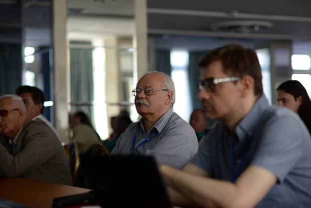 A group of people looking at a computer

Description generated with very high confidence