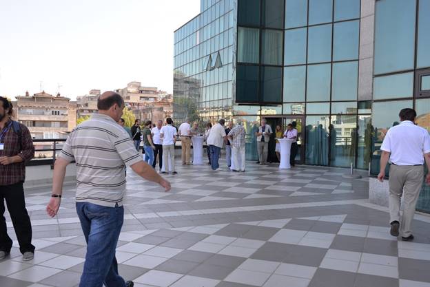 A group of people standing on a sidewalk

Description generated with very high confidence