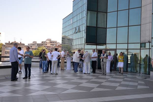 A group of people standing in front of a building

Description generated with very high confidence