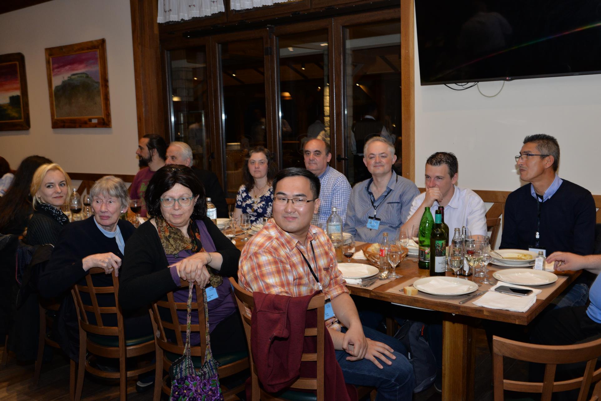 A group of people sitting at a table with wine glasses

Description automatically generated