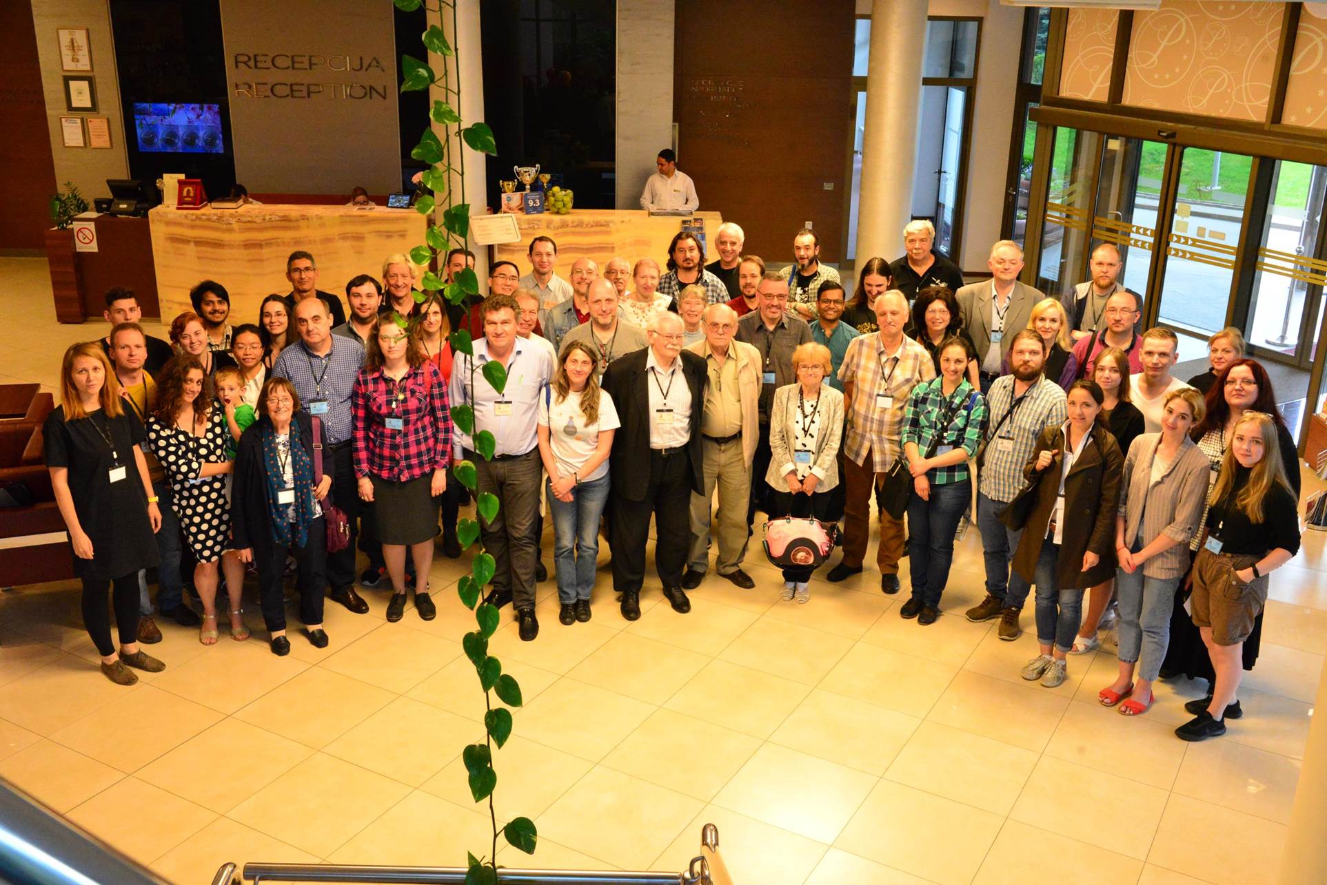 A group of people standing in front of a crowd posing for the camera

Description automatically generated