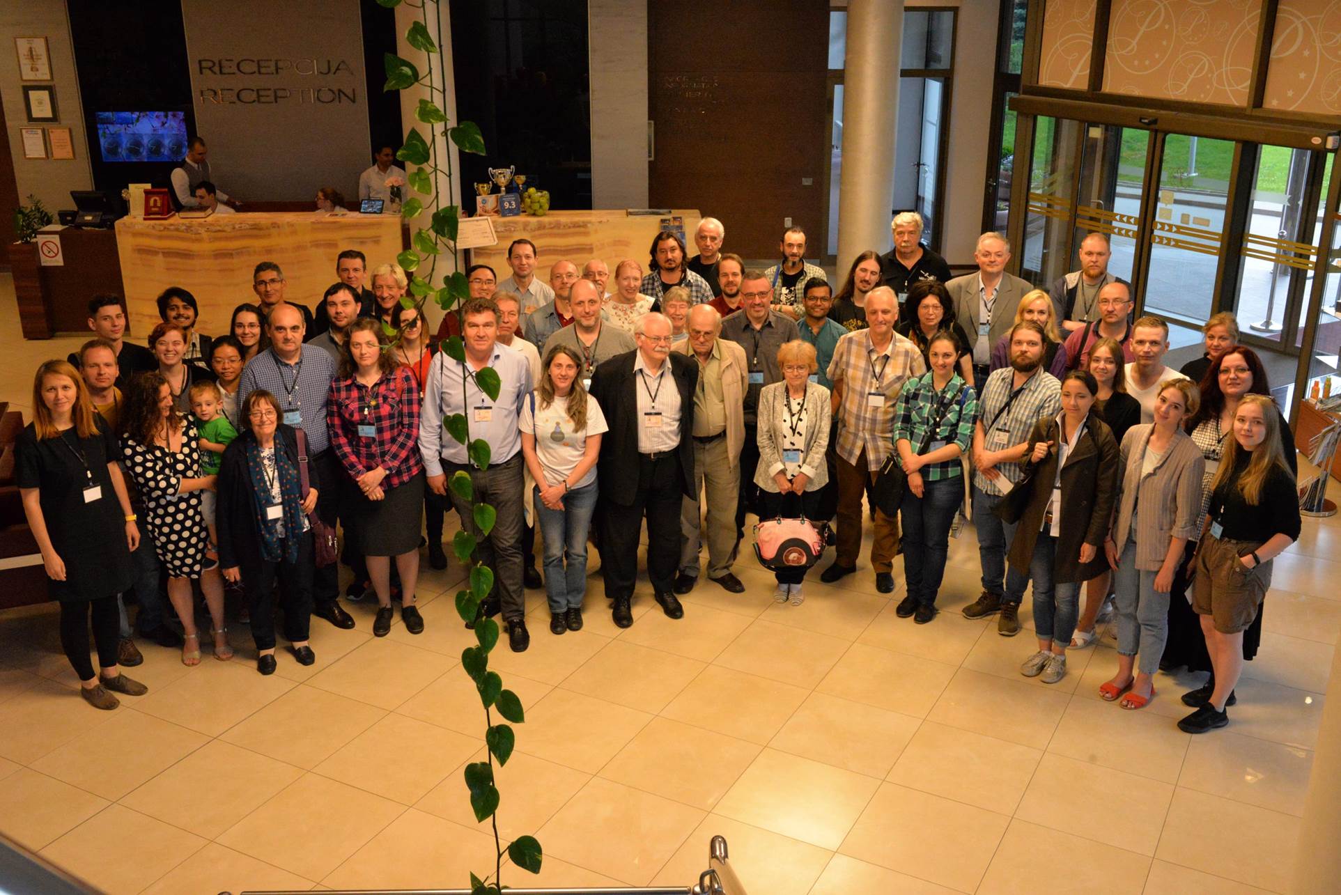 A group of people standing in front of a crowd posing for the camera

Description automatically generated