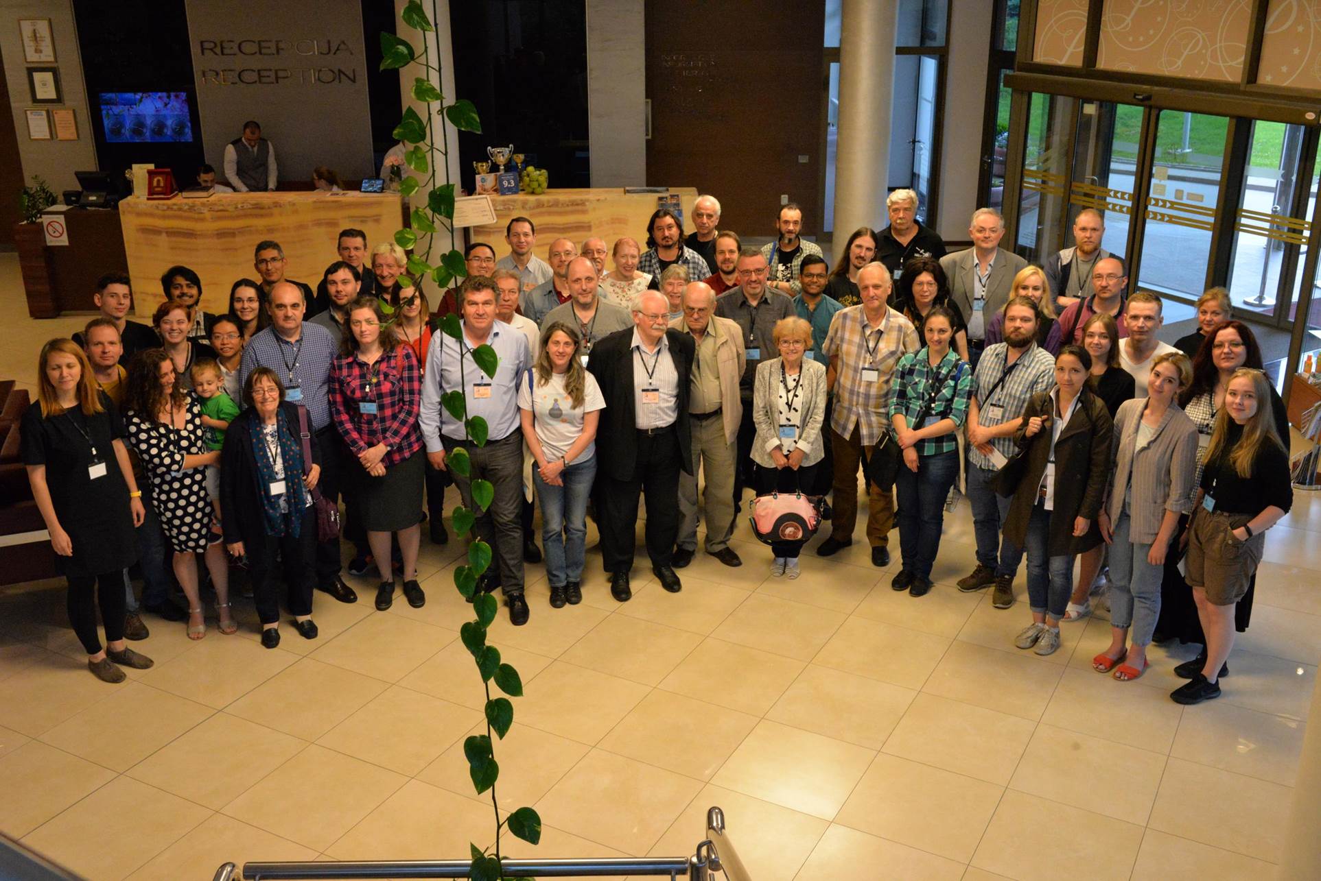 A group of people standing in front of a crowd posing for the camera

Description automatically generated