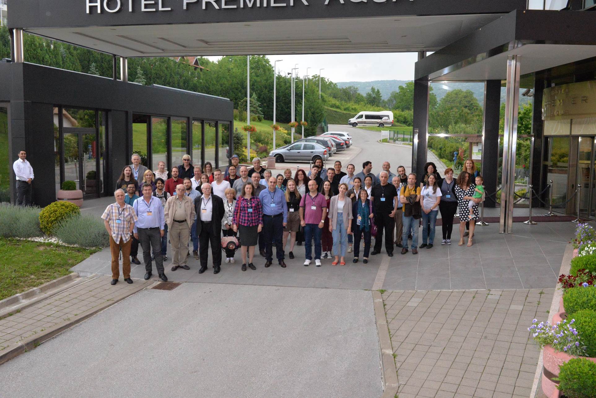 A group of people standing in front of a building

Description automatically generated