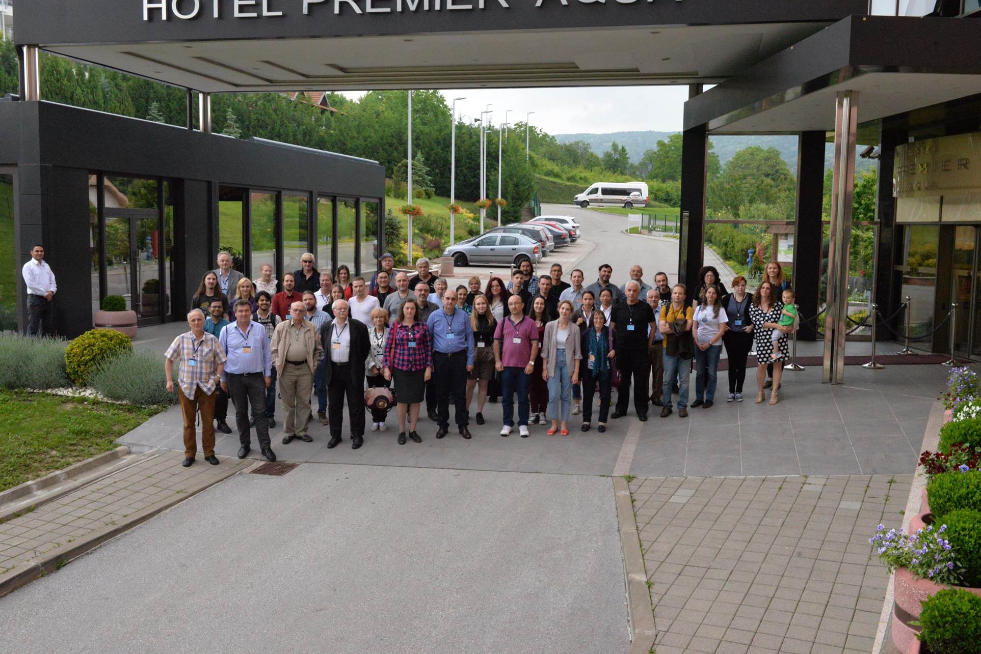 A group of people standing in front of a building

Description automatically generated