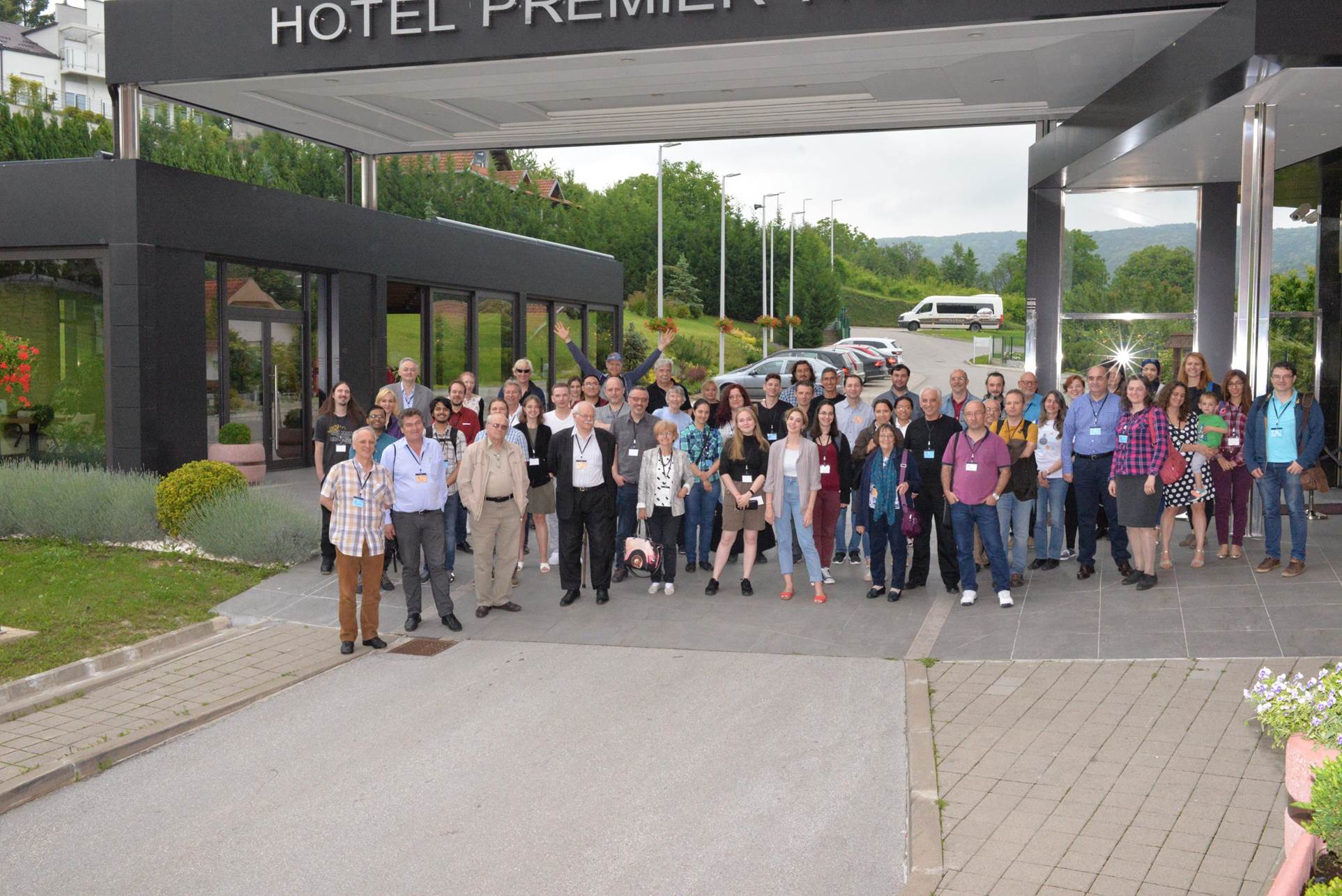 A group of people standing in front of a building

Description automatically generated