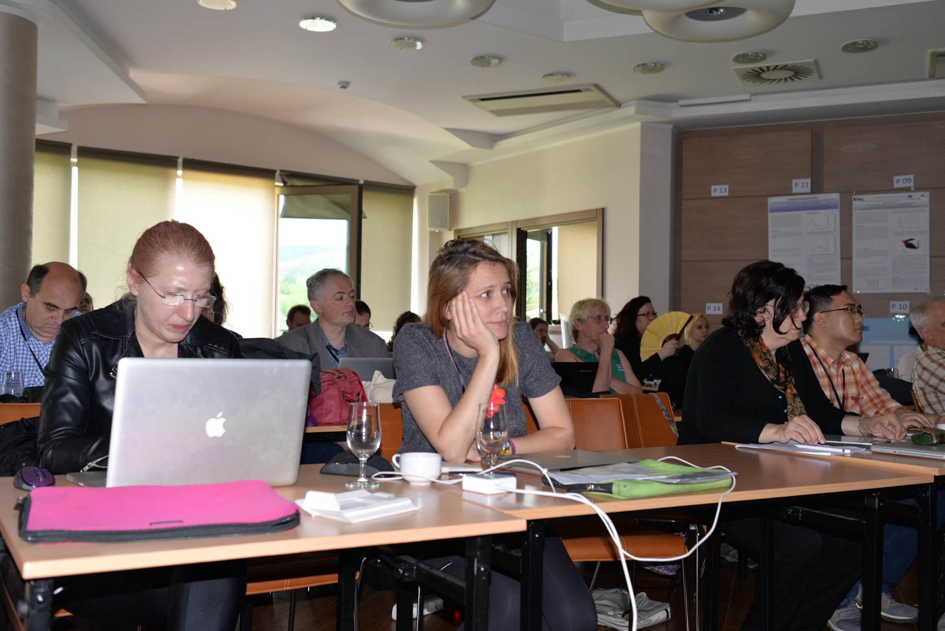 A group of people sitting at a table with a computer

Description automatically generated