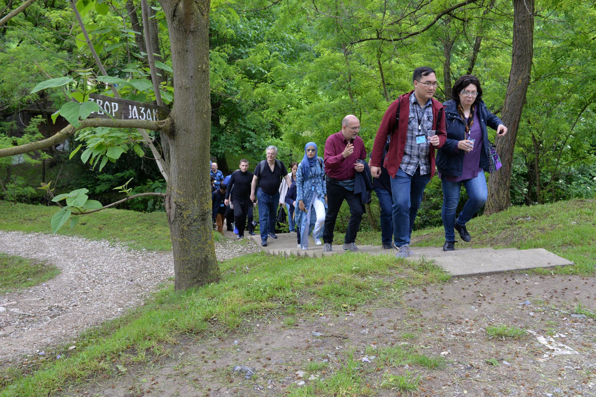 A group of people standing next to a tree

Description automatically generated