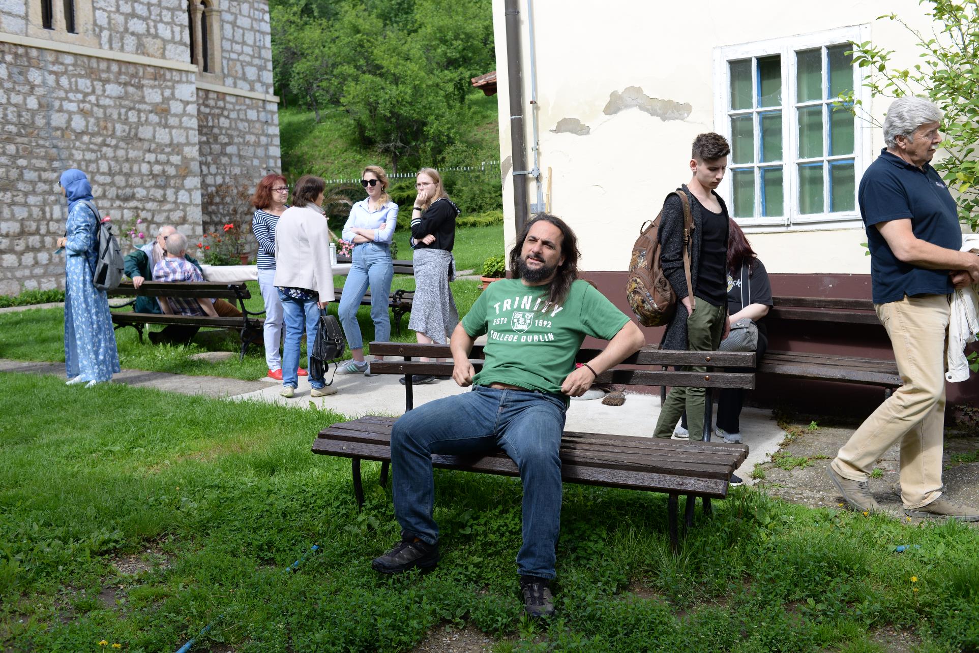 A group of people sitting on a bench

Description automatically generated