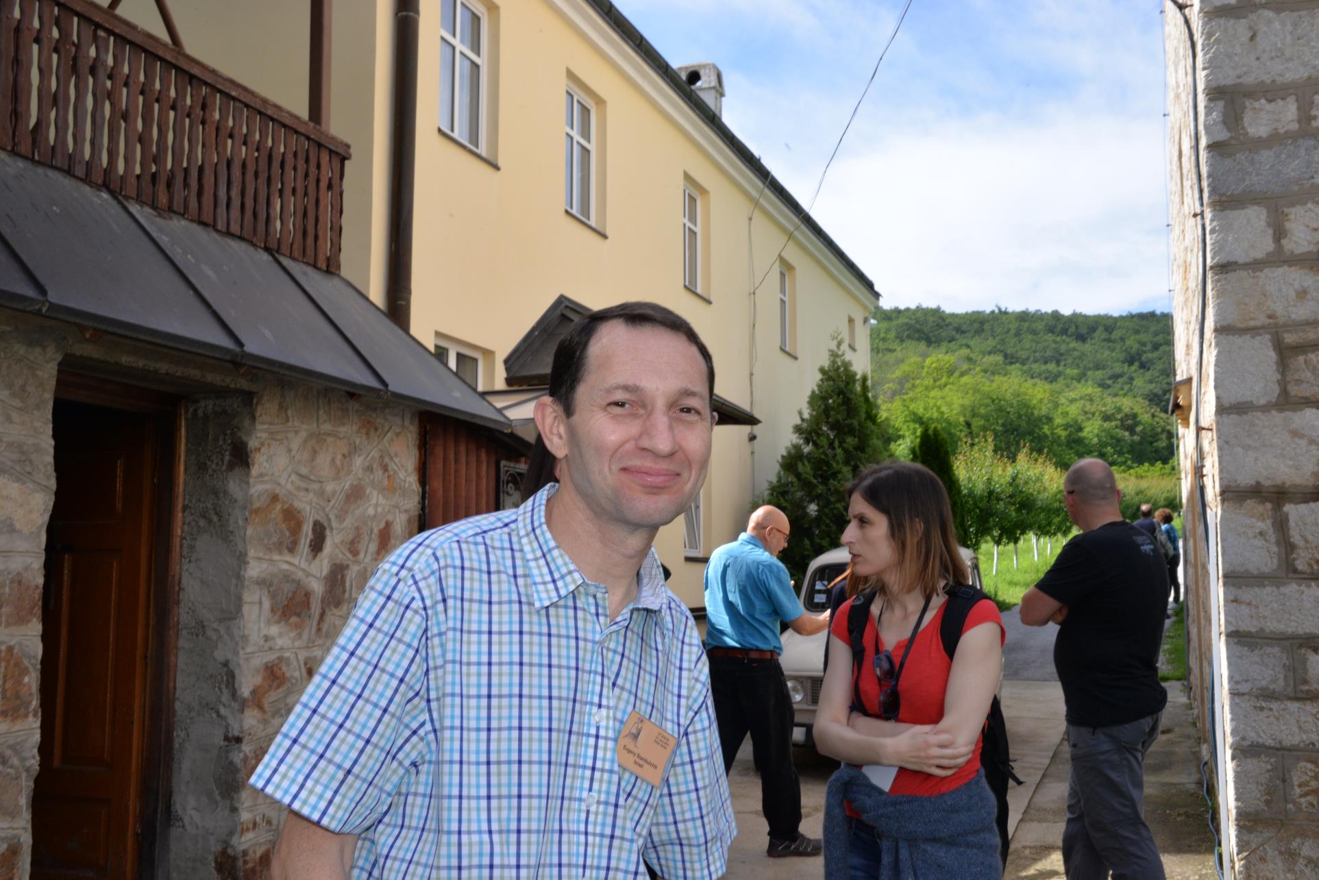 A group of people standing in front of a building

Description automatically generated