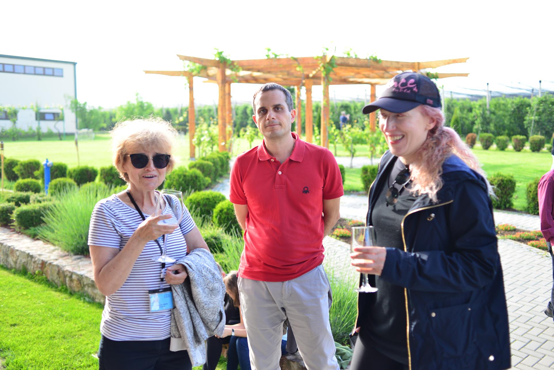 A group of people standing in the grass

Description automatically generated