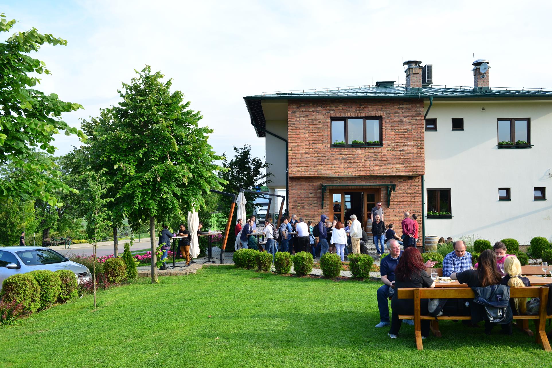 A group of people sitting in front of a house

Description automatically generated